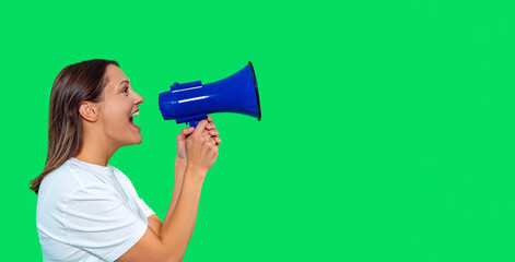 Woman using megaphone to communicate in front of green screen backdrop