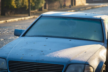 Frost snow covered car door handle and window in england uk