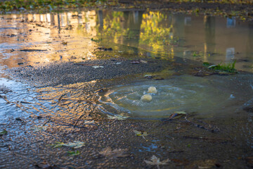 Water flood up through drain cover on ground in england uk