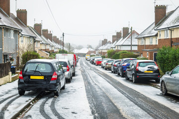 Frost snow covered british road and cars in england uk
