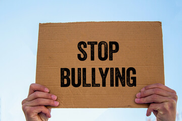 Stop bullying message written on cardboard sign. Conceptual stop bullying symbol. Copy space.