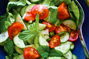 Vegetable salad with cucumber, lettuce and cherry tomatoes. Summer vegetables salad. Healthy and dietary food.