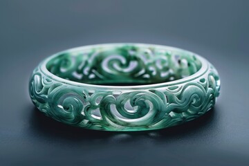 Intricately carved jade bracelet showcasing swirling patterns and floral motifs, crafted with skill and artistry, perfect for collectors and jewelry enthusiasts