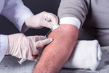 Close up Nurse collecting a blood from a patient