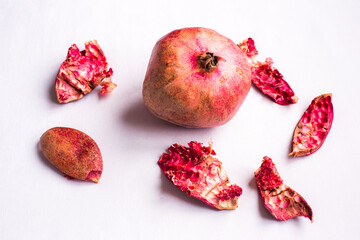 pomegranates and peel on a white background