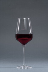 glass of red wine on grey background isolated studio shot