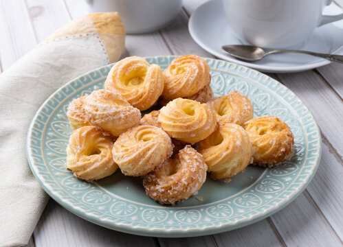 Samanta, typical brazilian sugar covered biscuit with coffee over wooden table