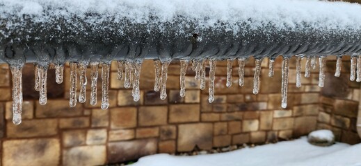 A frozen handrail with snow and ice.