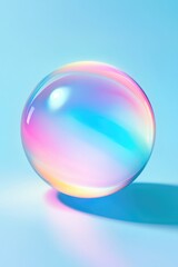 A shiny bubble with pink and blue hues, sitting on a reflective surface.