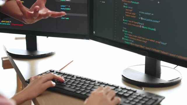 Slow motion back end or software developer manager supervising his team on new application program development on debugging and solving complex code algorithms on monitor. Burgeoning