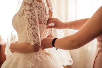 Hands adjusting wedding corset close-up