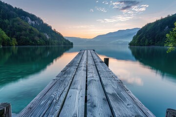 Beautiful sunrise over calm lake with wooden pier extending into the water surrounded by serene nature