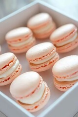 Obraz premium Delicate pink macarons arranged elegantly in white box, inviting