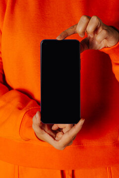 Crop person showing smartphone to camera