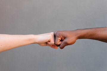 Fist bump between diverse hands symbolizing unity and friendship
