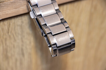 Close-up of a stylish metal watch bracelet, highlighting its intricate details and modern design....