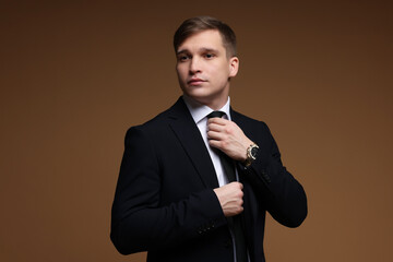 Man in classic suit on brown background