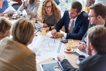 Diverse group in business meeting, discussing plans. Professionals collaborating, sharing ideas....