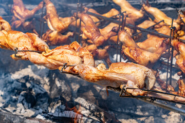 Huli-huli chicken is a grilled chicken dish in Hawaiian cuisine, prepared by barbecuing a chicken over mesquite wood, and basting it with a sweet huli-huli sauce.