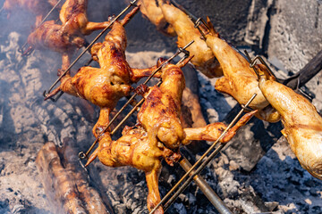 Huli-huli chicken is a grilled chicken dish in Hawaiian cuisine, prepared by barbecuing a chicken over mesquite wood, and basting it with a sweet huli-huli sauce.