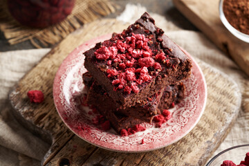 Homemade gluten-free brownies made with red kidney beans, oat flakes, chocolate and freeze-dried raspberries