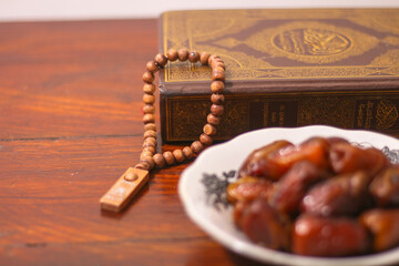 Dates and Muslim prayer beads, on a Wooden Table, Ramadan or Islamic Feast