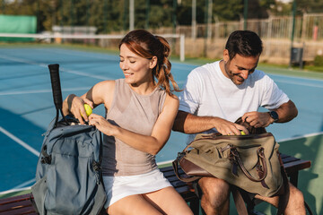 Young couple playing tennis outdoors enjoying a fun summer game