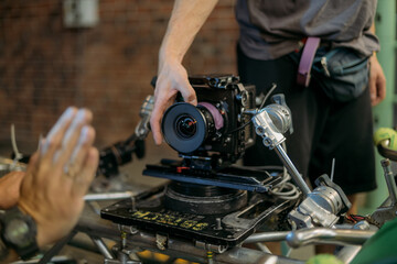 Obraz premium Professional cinema and video camera on the set. Shooting shift, lighting fixtures, shooting equipment and the team.