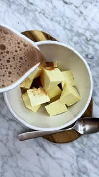 Delicious bowl of hot creamy chocolate with fresh cheese   