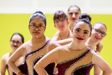 Diverse disabled gymnasts radiating unity and joy in colorful outfits
