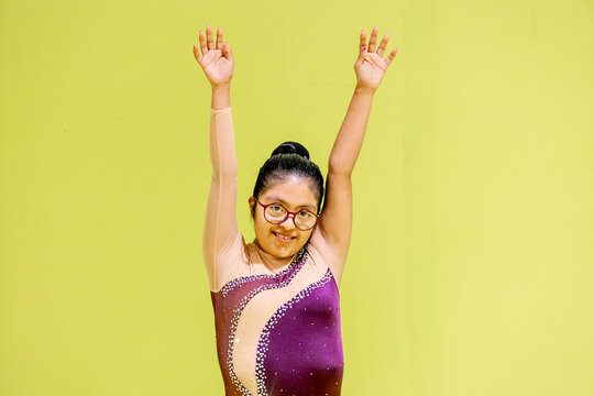 Young Gymnast whit disability Raising Arms in Portrait