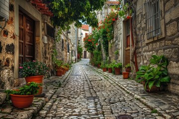 Fototapeta premium Charming cobblestone alleyway adorned with lush greenery and vibrant flowers, inviting exploration in a serene urban setting
