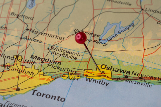 Tourist map of Ontario with a red pin stuck in next to Oshawa. Colorful map
