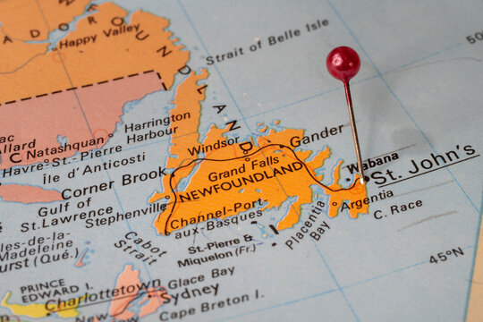 Tourist map of Newfoundland with a red pin stuck in next to St. John&rsquo;s. Colorful map
