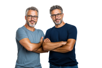 Two identical twin men stand side by side with arms crossed, smiling confidently. They wear casual clothing suitable for a professional business setting