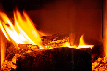 A Brightly Burning Log Fire Bringing Heat To A Room