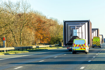 A Large Transporter Travelling Along A Motorway To Deliver A Giant Silo Or Hopper