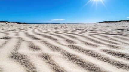 Naklejka premium A deserted beach reveals a smooth expanse of white sand under a vibrant blue sky, evoking tranquility and peace