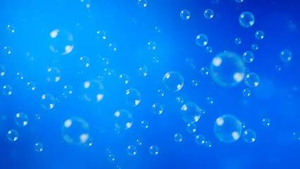 Clear, transparent water droplets glisten on a cool blue background
