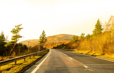 Obraz premium A Scottish Highland Road Taking Vehicles Through The Most Stunning Scenery