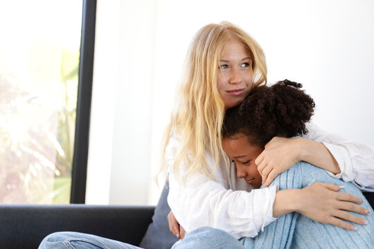 Supportive Hug Between Woman and Girl on the Couch