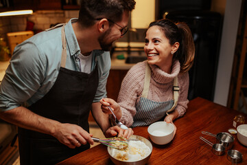 Couple enjoying baking together in cozy kitchen