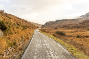 A Scottish Highland Road Taking Vehicles Through The Most Stunning Scenery