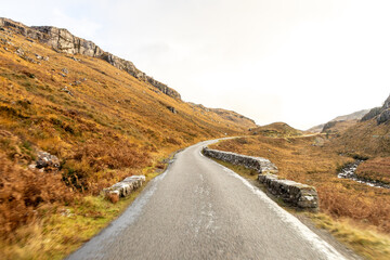 A Scottish Highland Road Taking Vehicles Through The Most Stunning Scenery