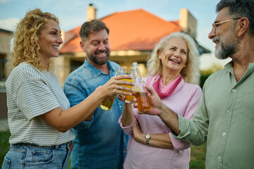 Group of friends making a toast at garden party