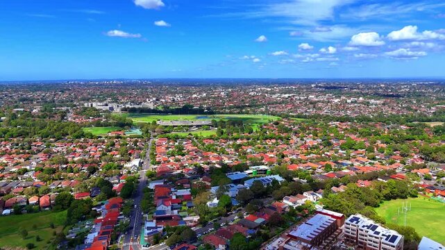 Aerial Drone view of Sydney Urban Sprawl and Suburban housing Suburb of Ashbury and Croydon with roof tops, the streets and the parks NSW Australia