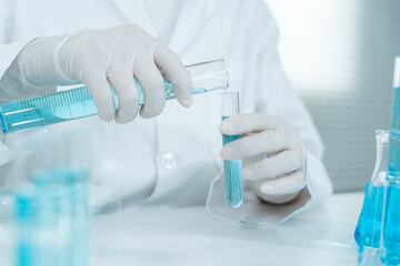 Fototapeta premium Scientist analyze biochemical samples in advanced scientific laboratory. Medical professional use dropper mix microbiological developmental of viral. Biotechnology research in science lab. cosmetic