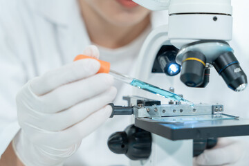 Scientist analyze biochemical samples in advanced scientific laboratory. Medical professional use...