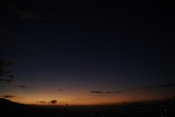 City lights glow under a dusky sky