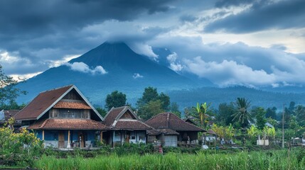 Scenic view of traditional houses with a mountain backdrop under a cloudy sky.